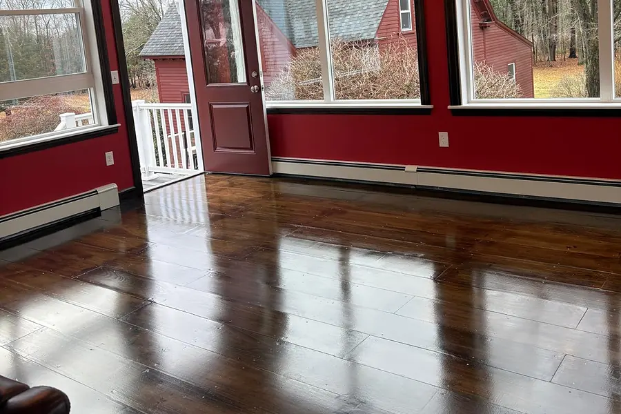 Wide-plank hardwood floors in a finished addition with large windows