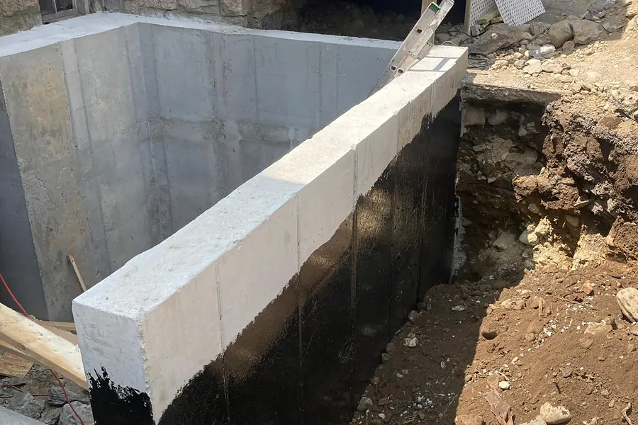 New poured concrete foundation walls with waterproofing