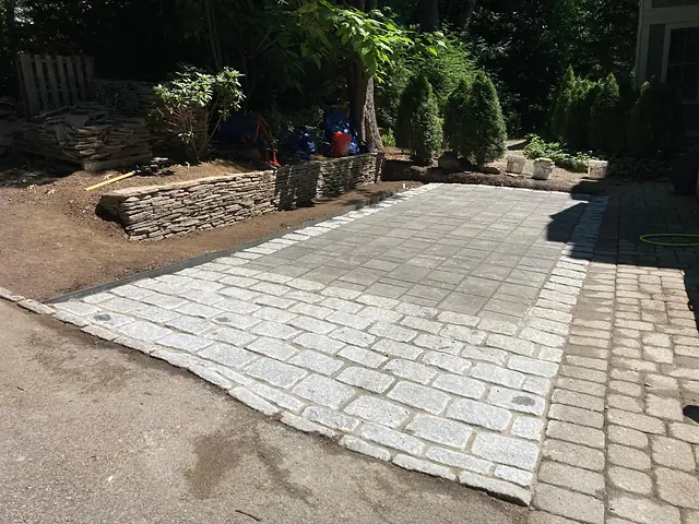 Cobblestone apron and stone wall