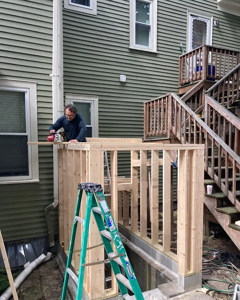 Mr. Costa, owner of DMC Construction, framing a new basement entry